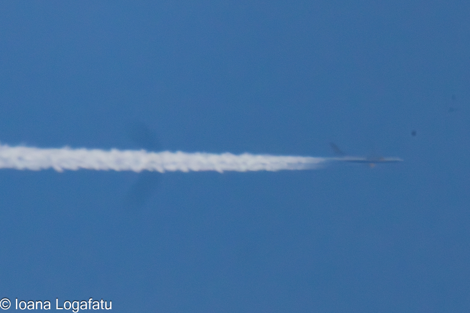 Traces of a jet gliding through a bright sky